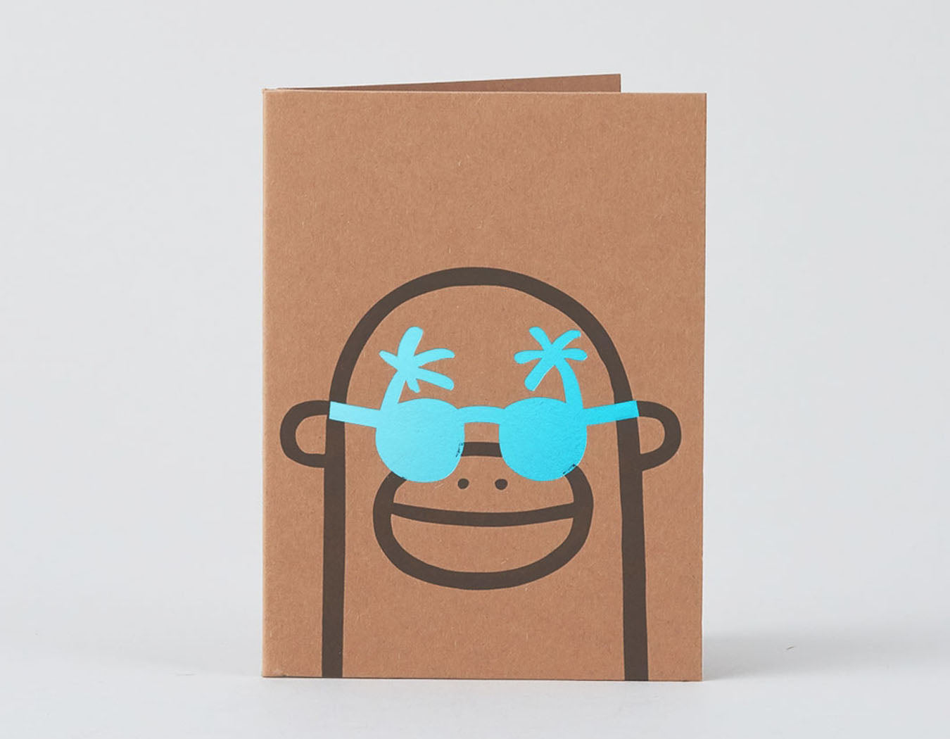 monkey smiling with gold foil blue sunglasses
