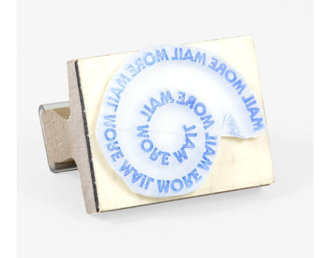 rubber stamp with mail more love written in a spiral 