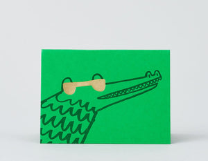 green background alligator with gold foil sunglasses 