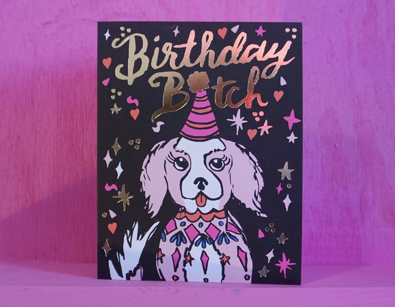 gold foil text reads birthday bitch party sparkles surround happy dog illustration