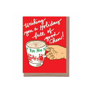 red background hand holding holiday mug scratch and sniff egg nog scent- text reads wishing you a holiday full of good cheer!