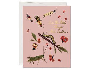 pale pink background gold foil text it's the little things that matter illustrated insects and twig