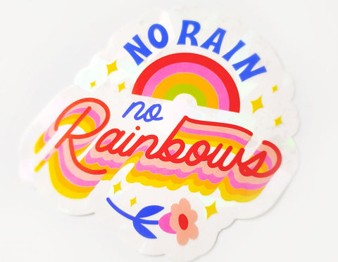 suncatcher sticker text reads no rain no rainbows has a mini rainbow and flower