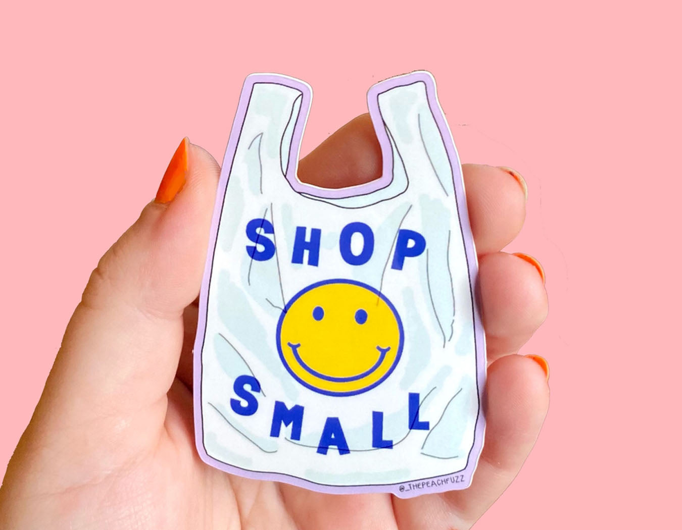 sticker in the shape of a shopping bag has a smiley face and text reads shop small