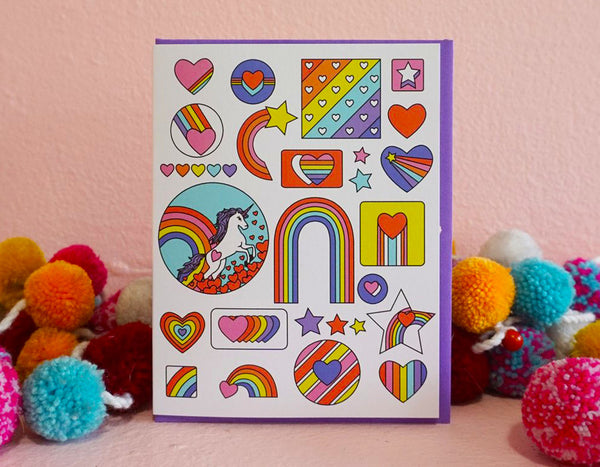 reminds me of retro sticker sheets this card features illustrations of rainbows hearts stars and a unicorn