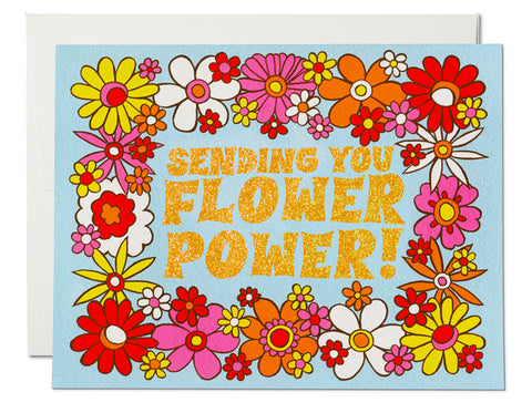 blue background 60s 70s flowers text reads sending you flower power!