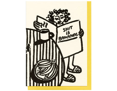 cream colored background  woman reading newspaper that says shit is bananas on cover. sitting at a striped tablecloth with black coffee and plate of bananas 